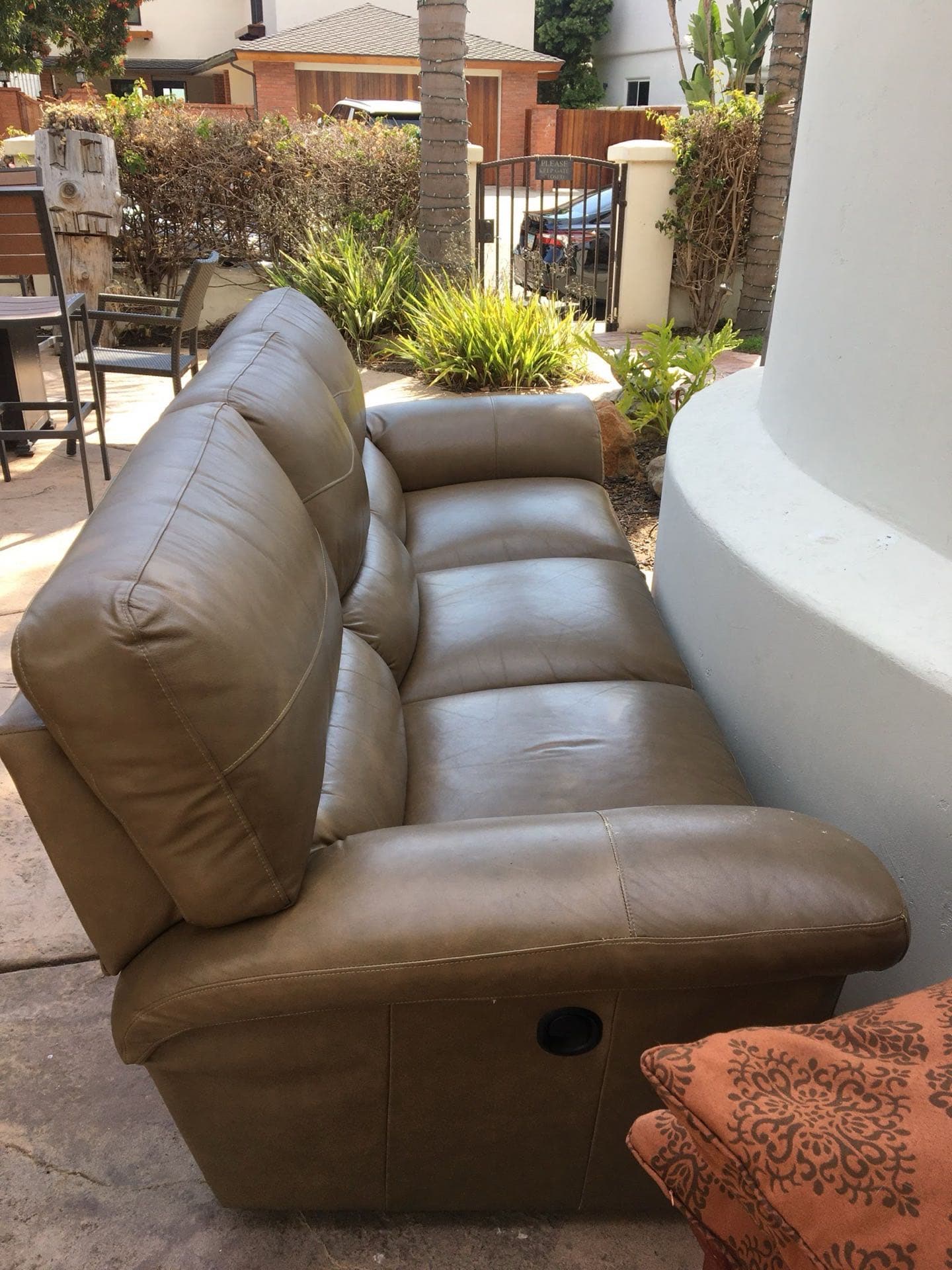 Brown leather couch left curbside for JunkMD+ furniture removal in a San Diego neighborhood